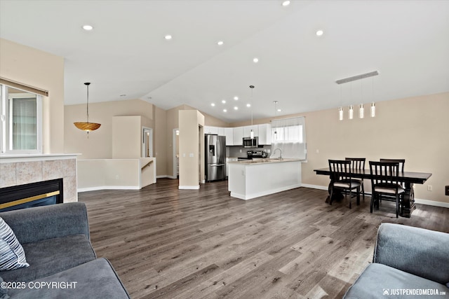 369 Breeze Ct # 13, Anchorage, AK 99515 - living area with vaulted ceiling, dark wood-type flooring, recessed lighting, and a tile fireplace