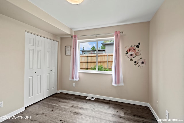 369 Breeze Ct # 13, Anchorage, AK 99515 - unfurnished bedroom with wood finished floors and a closet