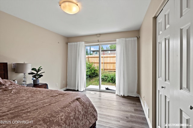 369 Breeze Ct # 13, Anchorage, AK 99515 - bedroom featuring access to outside and wood finished floors