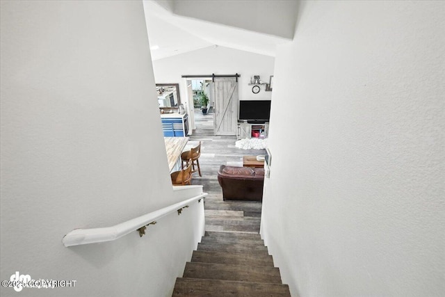 16720 E Maud Rd, Palmer, AK 99645 - stairway featuring vaulted ceiling, wood finished floors, and a barn door