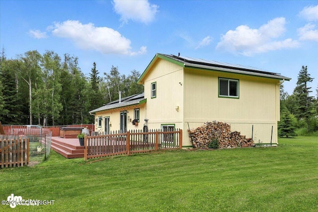 16720 E Maud Rd, Palmer, AK 99645 - rear view of house featuring roof mounted solar panels and a deck