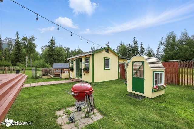 16720 E Maud Rd, Palmer, AK 99645 - fenced backyard with an outbuilding and a wooden deck