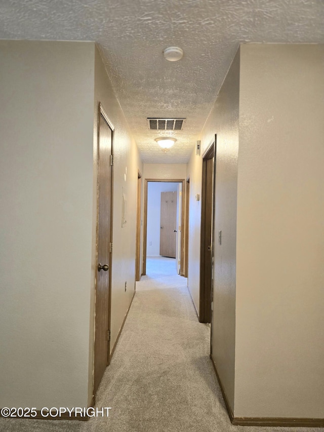 1120 China Berry Cir, Anchorage, AK 99515 - hallway featuring a textured ceiling and light carpet