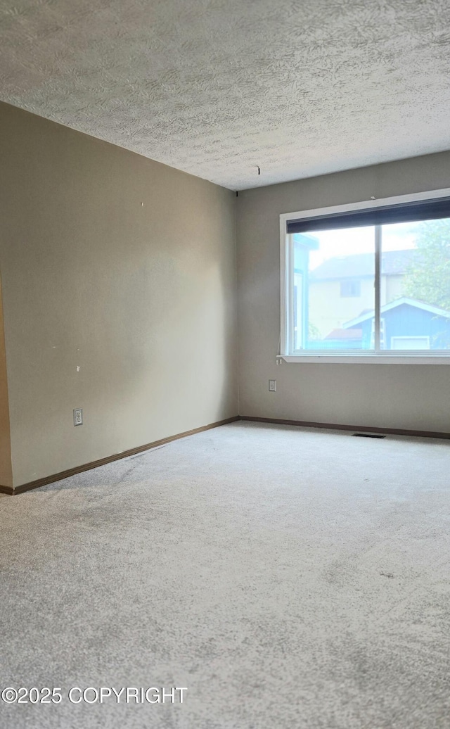 1120 China Berry Cir, Anchorage, AK 99515 - carpeted empty room featuring a textured ceiling and baseboards