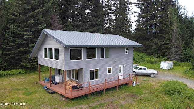 2008 Bickford Cir, Seldovia, AK 99663 - rear view of property with a deck, a forest view, a lawn, and a metal roof