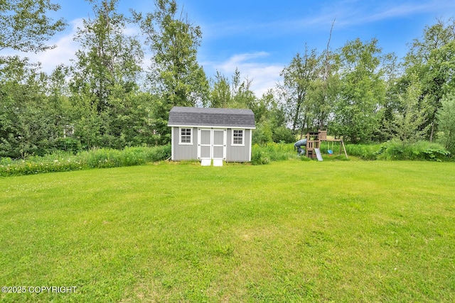 5305 N Caprice Dr, Palmer, AK 99645 - view of green lawn with a storage shed and a playground