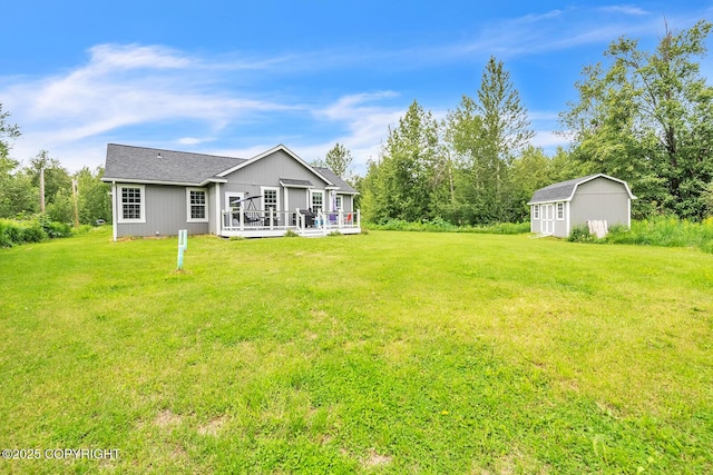 5305 N Caprice Dr, Palmer, AK 99645 - rear view of property featuring a storage unit, a wooden deck, and a yard