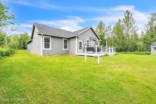 5305 N Caprice Dr, Palmer, AK 99645 - rear view of house featuring a wooden deck, a lawn, and roof with shingles