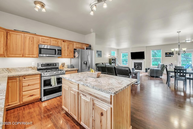 5305 N Caprice Dr, Palmer, AK 99645 - kitchen featuring stainless steel appliances, dark wood finished floors, a kitchen island, a chandelier, and light stone countertops