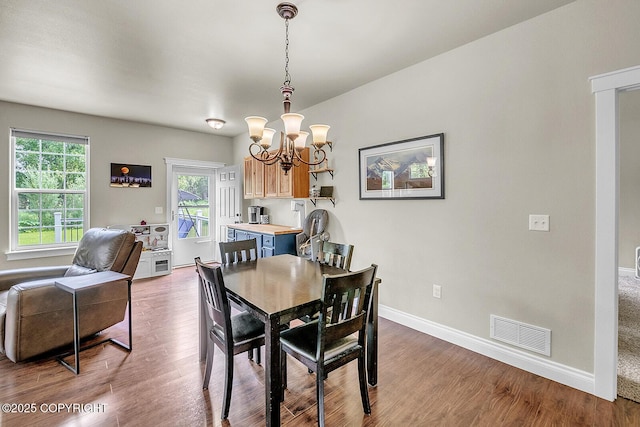5305 N Caprice Dr, Palmer, AK 99645 - dining area featuring a chandelier and wood finished floors