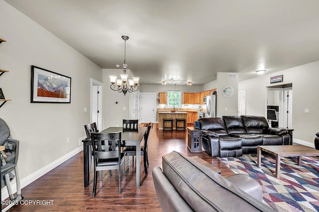 5305 N Caprice Dr, Palmer, AK 99645 - dining space with a chandelier and dark wood-style flooring