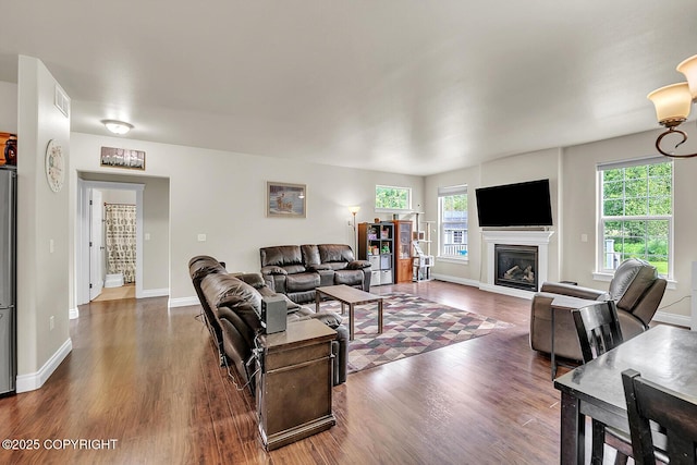 5305 N Caprice Dr, Palmer, AK 99645 - living room featuring dark wood-style flooring, healthy amount of natural light, and a glass covered fireplace