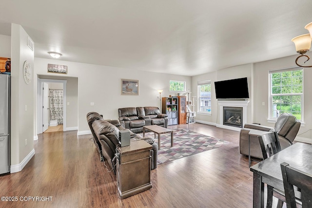 5305 N Caprice Dr, Palmer, AK 99645 - living area featuring dark wood-style flooring, healthy amount of natural light, and a glass covered fireplace