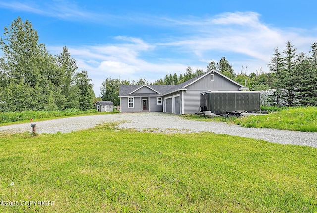 5305 N Caprice Dr, Palmer, AK 99645 - ranch-style home featuring gravel driveway, a front lawn, and a garage