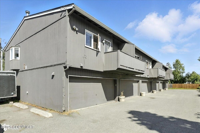 3601 Oregon Dr # 1, Anchorage, AK 99517 - view of side of property with a balcony and a garage