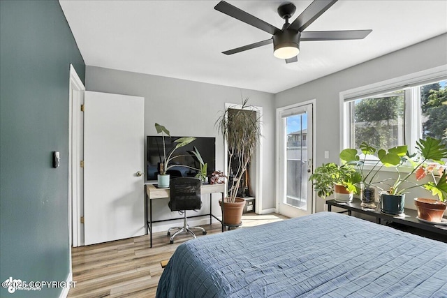 3601 Oregon Dr # 1, Anchorage, AK 99517 - bedroom featuring access to outside, wood finished floors, multiple windows, and ceiling fan