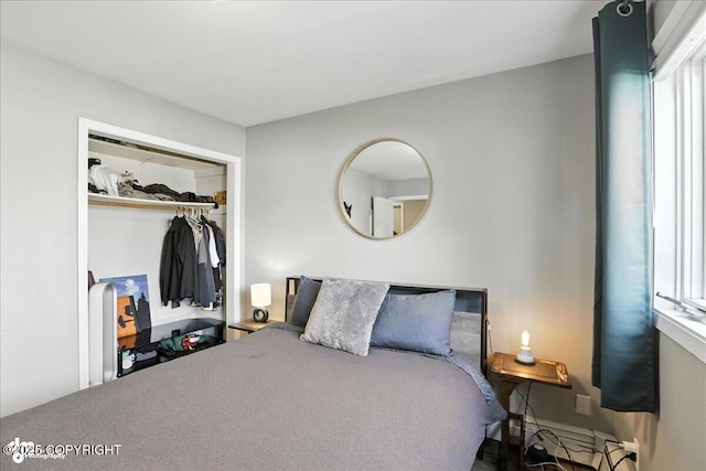 3601 Oregon Dr # 1, Anchorage, AK 99517 - bedroom featuring a closet, multiple windows, and baseboard heating