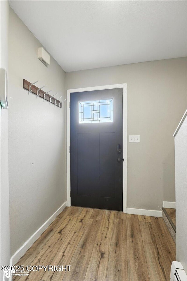 3601 Oregon Dr # 1, Anchorage, AK 99517 - foyer with a baseboard radiator and wood finished floors