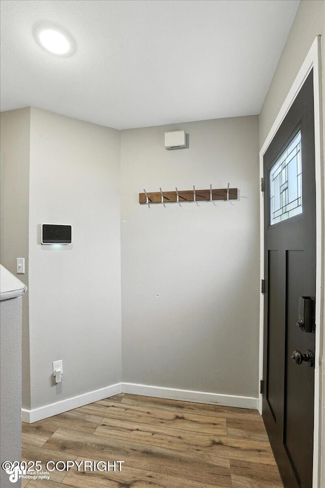 3601 Oregon Dr # 1, Anchorage, AK 99517 - laundry room featuring wood finished floors and baseboards