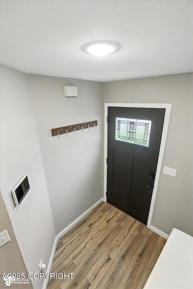 3601 Oregon Dr # 1, Anchorage, AK 99517 - entryway with wood finished floors and a textured ceiling