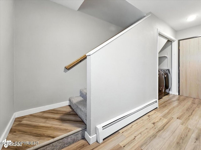 3601 Oregon Dr # 1, Anchorage, AK 99517 - stairway with washer and dryer, baseboard heating, and wood finished floors