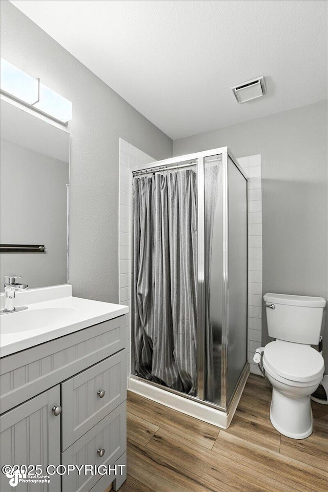 3601 Oregon Dr # 1, Anchorage, AK 99517 - full bathroom with vanity, a shower stall, and wood finished floors