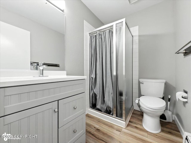 3601 Oregon Dr # 1, Anchorage, AK 99517 - full bath with a stall shower, wood finished floors, vanity, and a baseboard radiator
