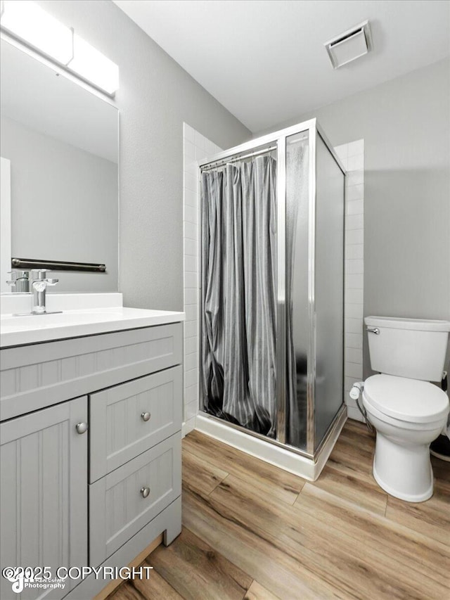 3601 Oregon Dr # 1, Anchorage, AK 99517 - full bathroom with wood finished floors, vanity, and a shower stall