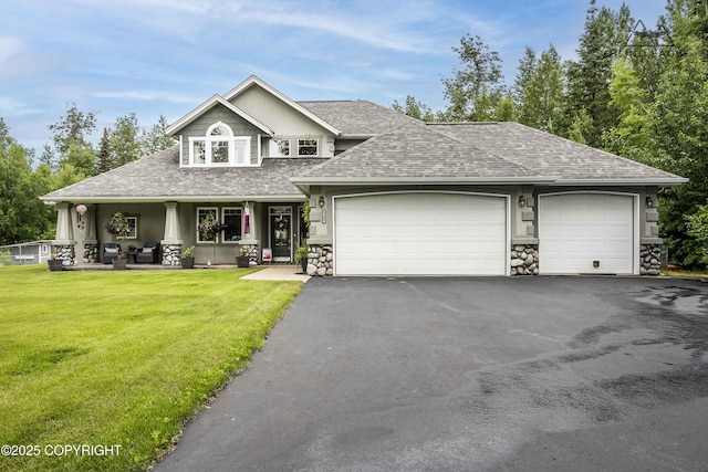 17237 E Smith Rd, Palmer, AK 99645 - view of front of home featuring a shingled roof, driveway, stone siding, a front lawn, and an attached garage