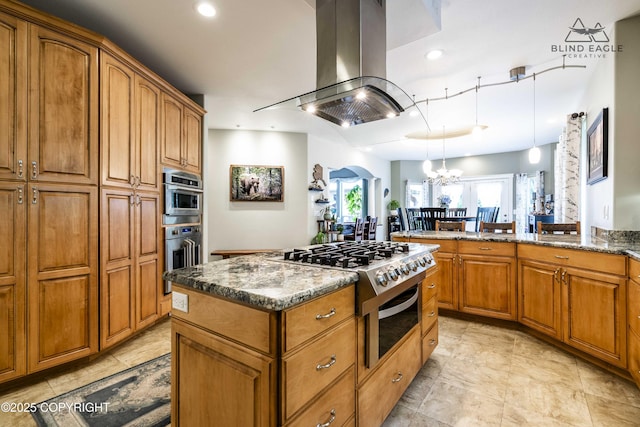 17237 E Smith Rd, Palmer, AK 99645 - kitchen featuring island exhaust hood, brown cabinets, a chandelier, a kitchen island, and dark stone countertops