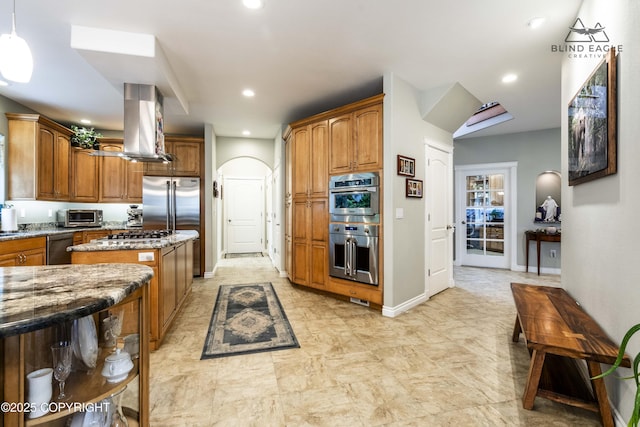 17237 E Smith Rd, Palmer, AK 99645 - kitchen featuring exhaust hood, a kitchen island, light stone countertops, stainless steel appliances, and brown cabinets
