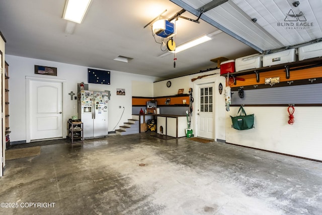 17237 E Smith Rd, Palmer, AK 99645 - garage featuring refrigerator with ice dispenser and a garage door opener