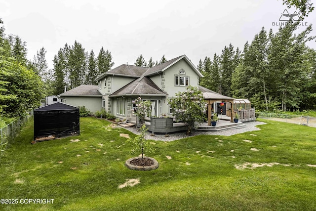 17237 E Smith Rd, Palmer, AK 99645 - rear view of house with a gazebo, a fenced backyard, stucco siding, a patio area, and roof with shingles