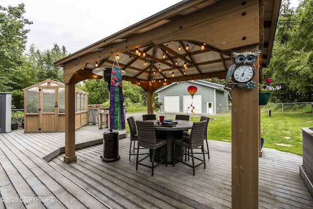 17237 E Smith Rd, Palmer, AK 99645 - wooden terrace featuring an outbuilding, outdoor dining space, a gazebo, and a garage