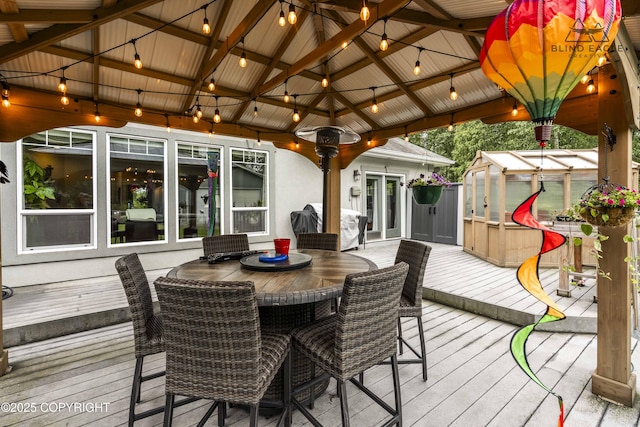 17237 E Smith Rd, Palmer, AK 99645 - wooden deck featuring an outdoor structure, a gazebo, an exterior structure, and outdoor dining area