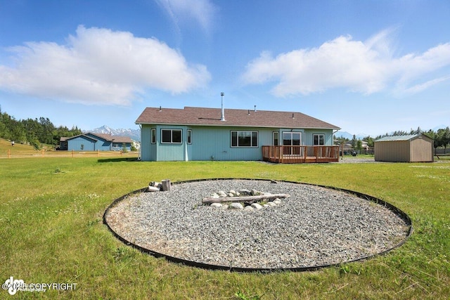 3098 N Lazy Aurora Cir, Palmer, AK 99645 - rear view of property featuring a storage shed, a deck, and a yard