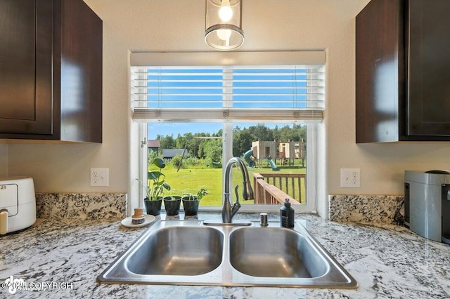 3098 N Lazy Aurora Cir, Palmer, AK 99645 - kitchen with dark brown cabinetry and light stone counters