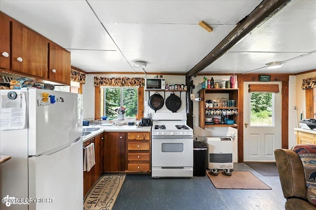 57541 Clam Diggers Ave, Clam Gulch, AK 99568 - kitchen with white appliances, plenty of natural light, brown cabinets, and dark wood-style floors