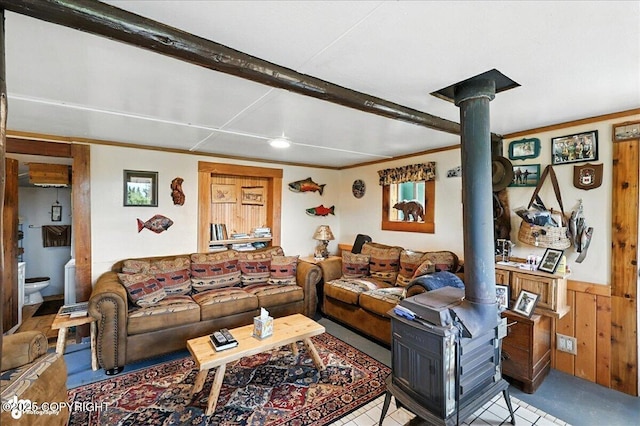 57541 Clam Diggers Ave, Clam Gulch, AK 99568 - living area with a wood stove, wooden walls, crown molding, and a wainscoted wall