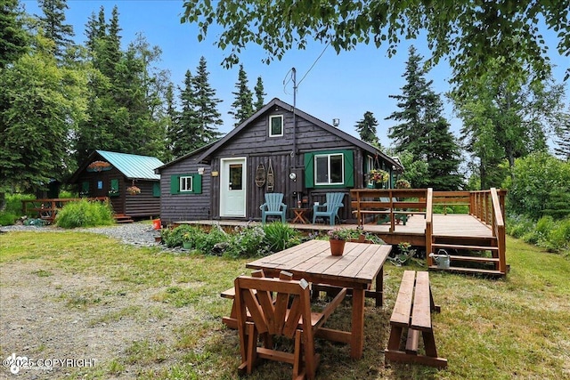 57541 Clam Diggers Ave, Clam Gulch, AK 99568 - back of property with a deck and a lawn