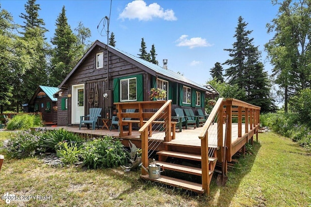 57541 Clam Diggers Ave, Clam Gulch, AK 99568 - back of property featuring a metal roof, a deck, and a lawn
