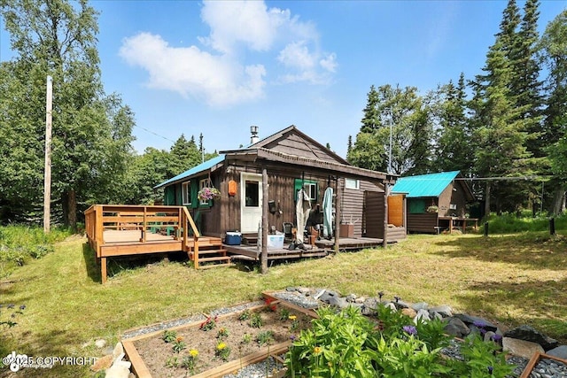 57541 Clam Diggers Ave, Clam Gulch, AK 99568 - rear view of house featuring a vegetable garden, a deck, and a yard