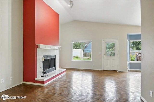 7851 Alpine View Cir, Anchorage, AK 99507 - unfurnished living room featuring healthy amount of natural light, hardwood / wood-style floors, a fireplace, and lofted ceiling