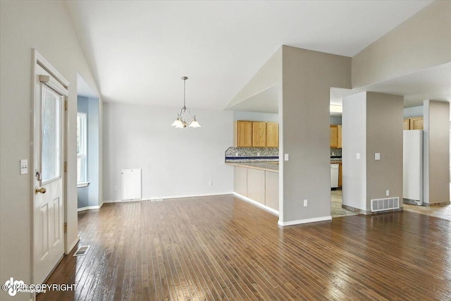 7851 Alpine View Cir, Anchorage, AK 99507 - unfurnished living room featuring a chandelier, hardwood / wood-style floors, and vaulted ceiling