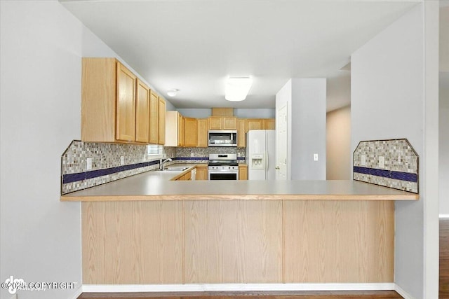 7851 Alpine View Cir, Anchorage, AK 99507 - kitchen with appliances with stainless steel finishes, light brown cabinetry, and a peninsula