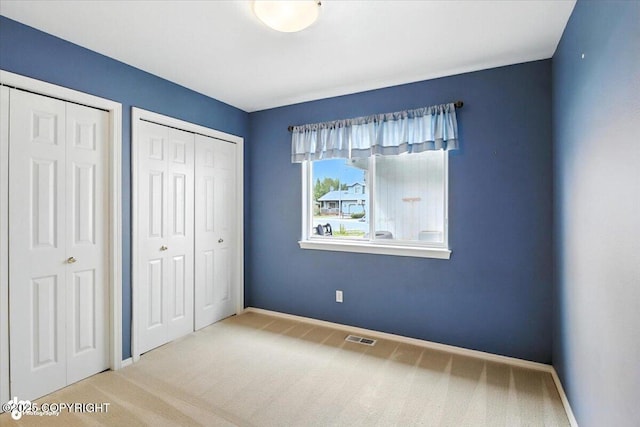 7851 Alpine View Cir, Anchorage, AK 99507 - unfurnished bedroom with carpet flooring and multiple closets