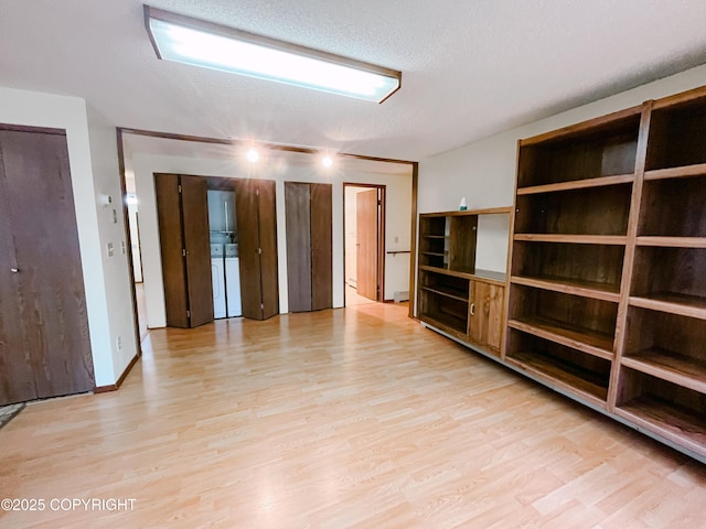 505 Unimak St, Petersburg, AK 99833 - empty room featuring light wood-style flooring, a textured ceiling, and washer / clothes dryer