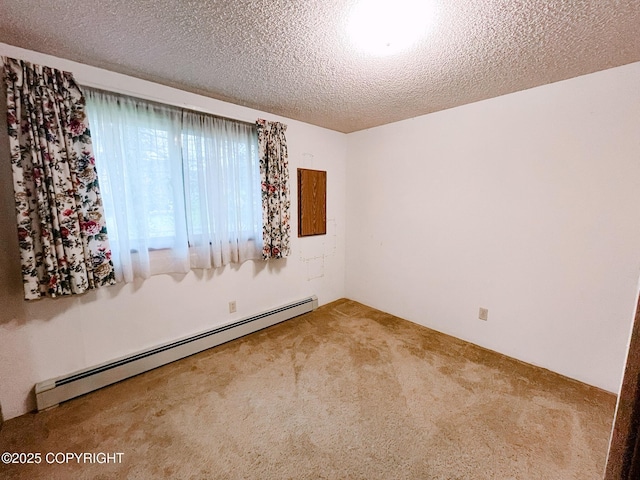 505 Unimak St, Petersburg, AK 99833 - empty room with baseboard heating, carpet flooring, and a textured ceiling