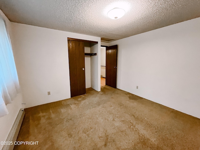 505 Unimak St, Petersburg, AK 99833 - unfurnished bedroom featuring light colored carpet, baseboard heating, a closet, and a textured ceiling