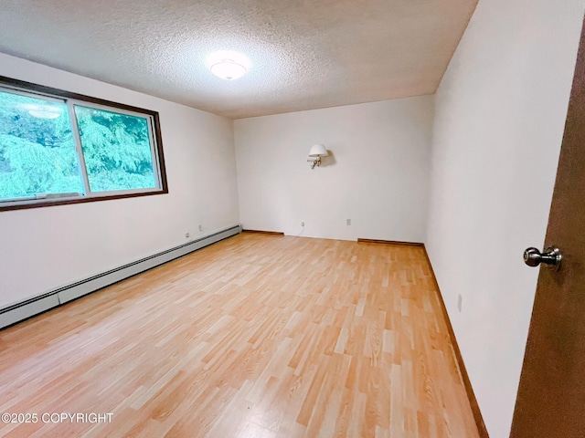 505 Unimak St, Petersburg, AK 99833 - unfurnished room featuring wood finished floors, a baseboard radiator, and a textured ceiling